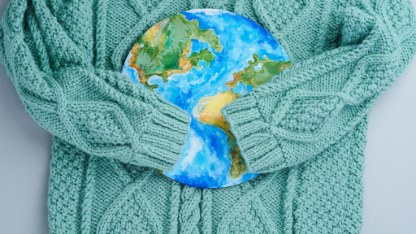 Sleeves of knitwear sweater hug the planet.